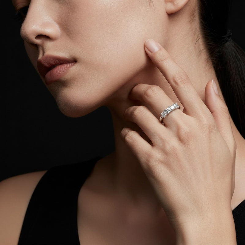Model wearing princess seven stone band ring