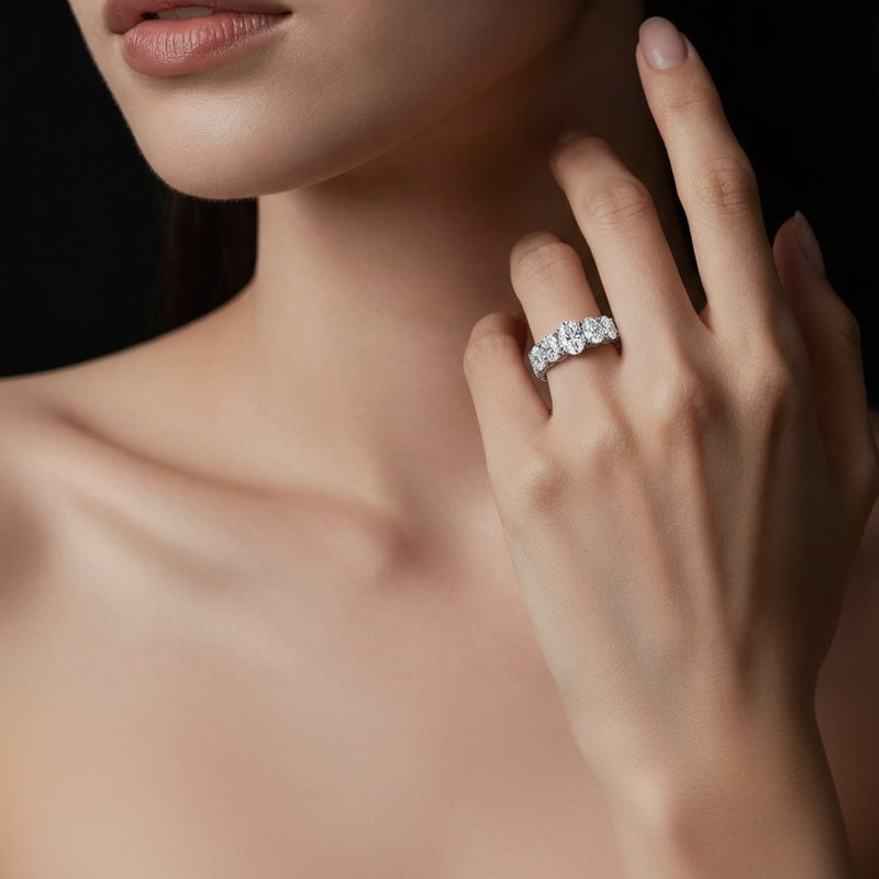 Model wearing oval seven stone band ring