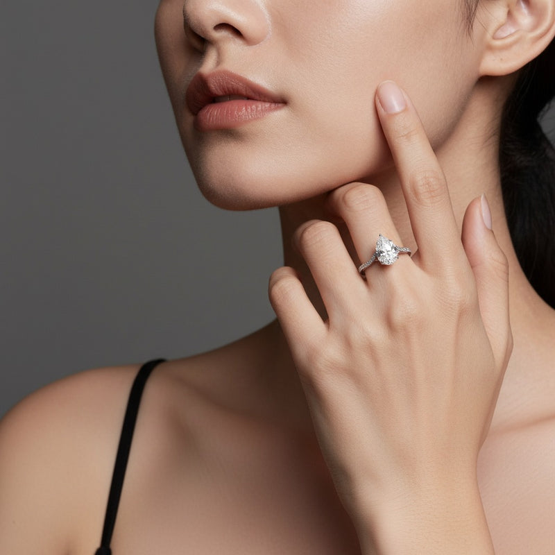 Model wearing pear fashion solitaire engagement ring