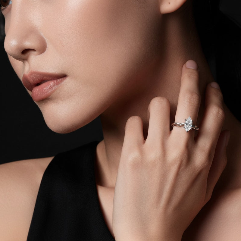 Model wearing marquise twisted shank solitaire engagement ring