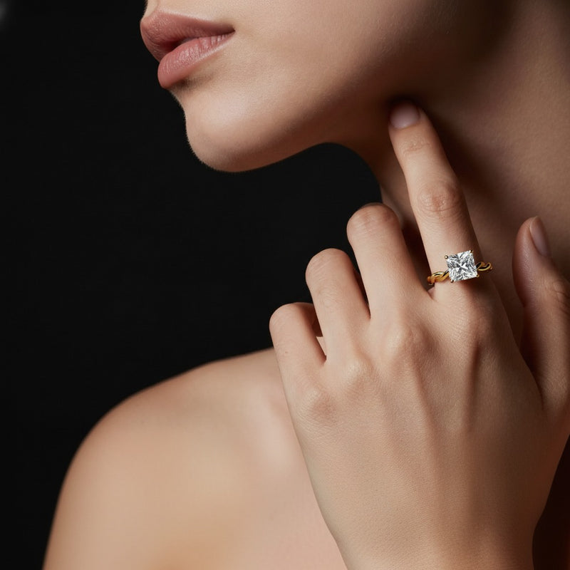 Model wearing princess twisted shank solitaire engagement ring