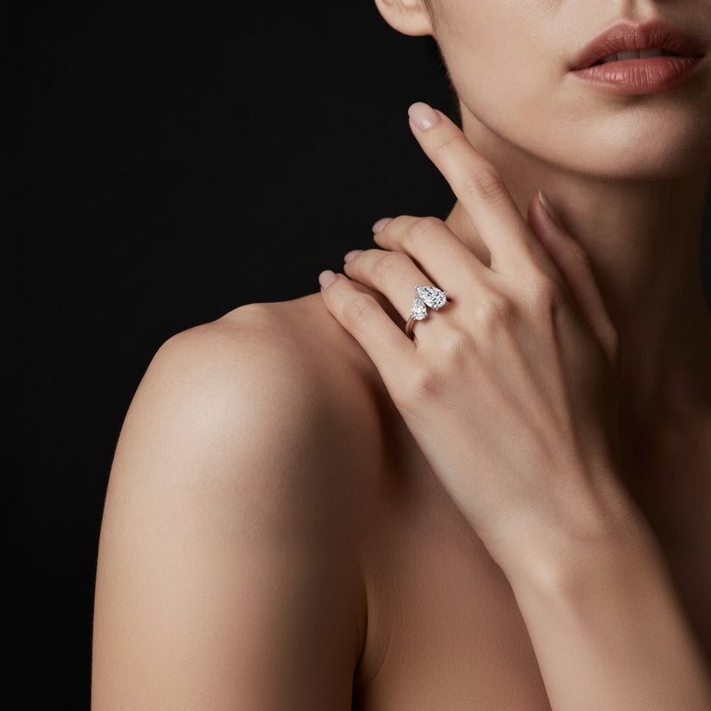 Model wearing pear toi et moi engagement ring