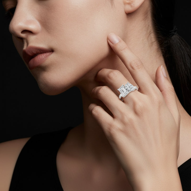 Model wearing emerald toi et moi engagement ring