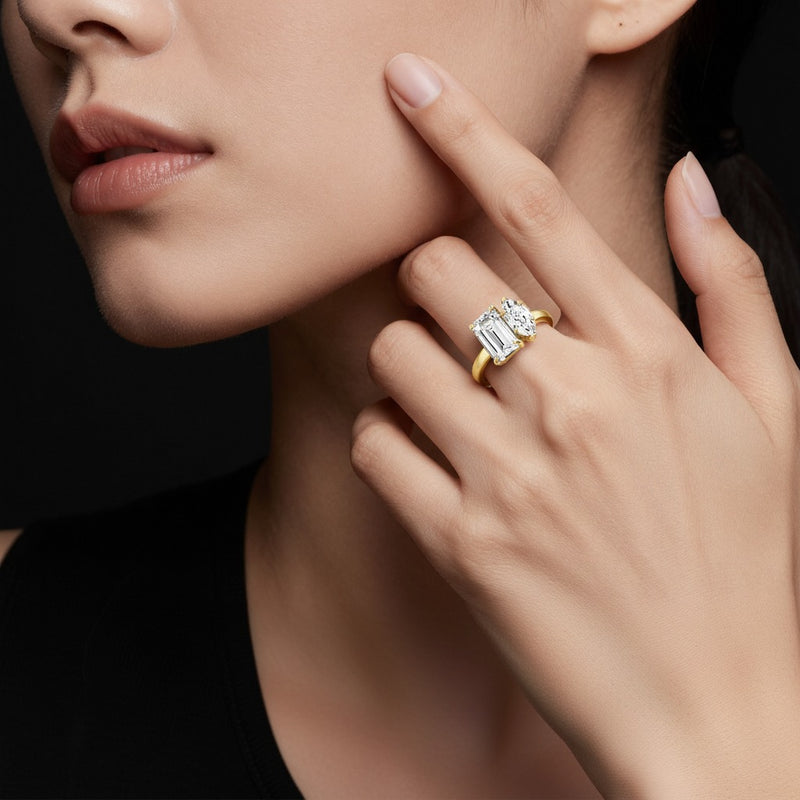 Model wearing emerald toi et moi engagement ring