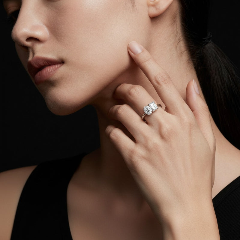 Model wearing emerald toi et moi engagement ring