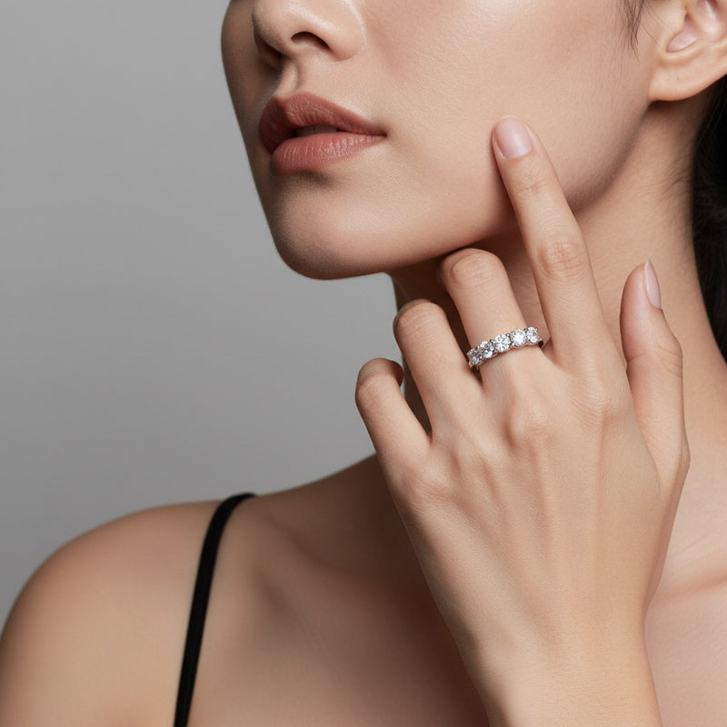 Model wearing round five stone band ring