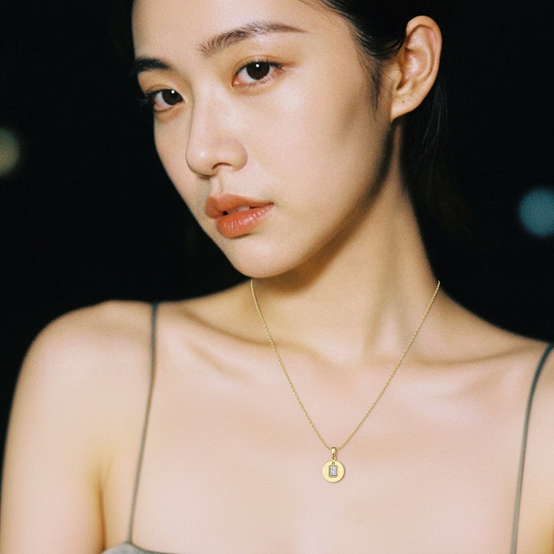 Model wearing emerald dog tag pendant
