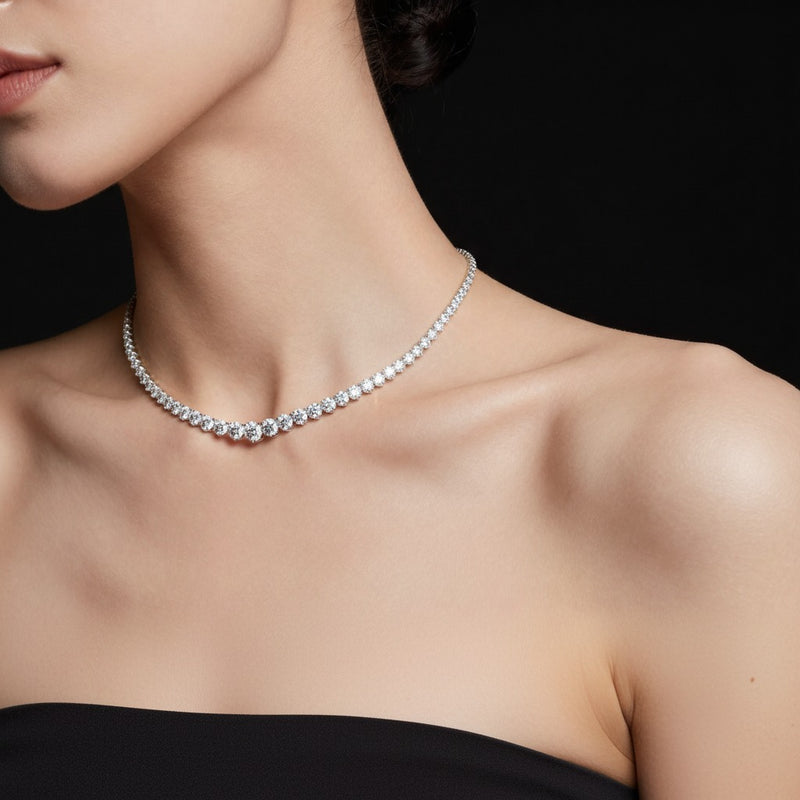 Model wearing round three prong graduating necklace