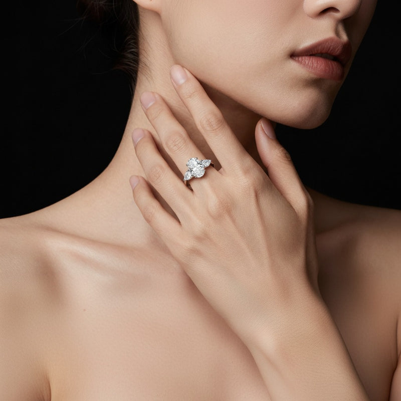 Model wearing oval accented three stone ring