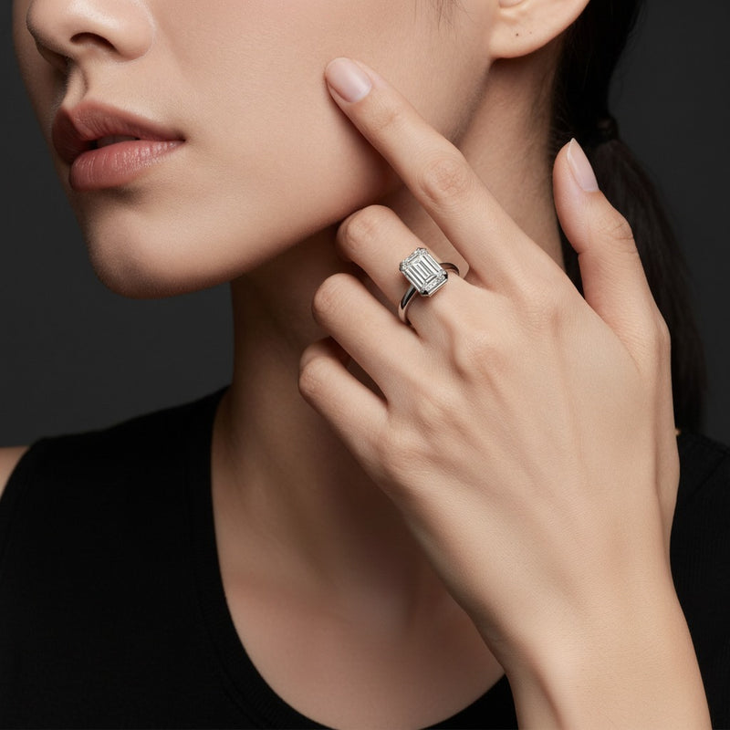 Model wearing emerald east west solitaire ring