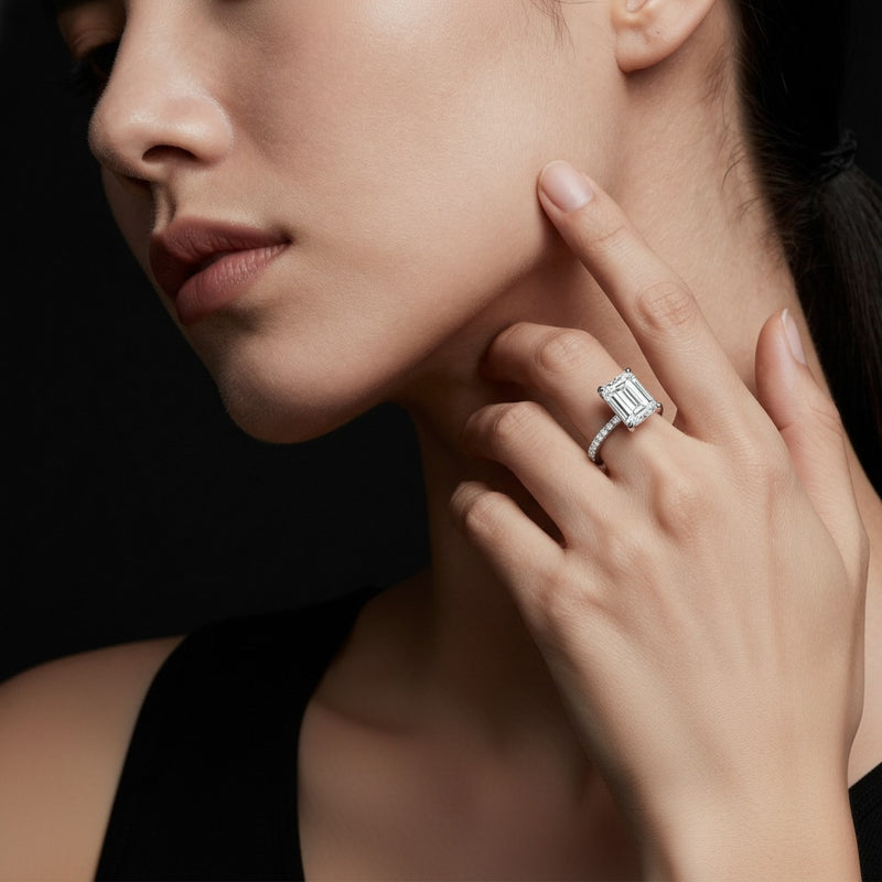 Model wearing emerald east west accented solitaire ring
