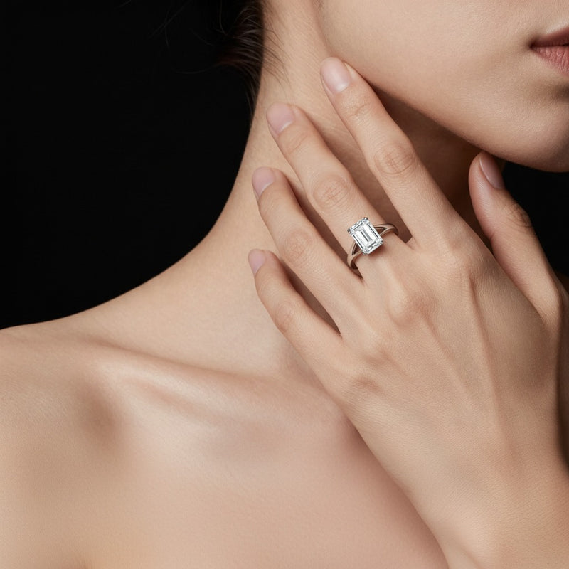 Model wearing emerald east west solitaire ring