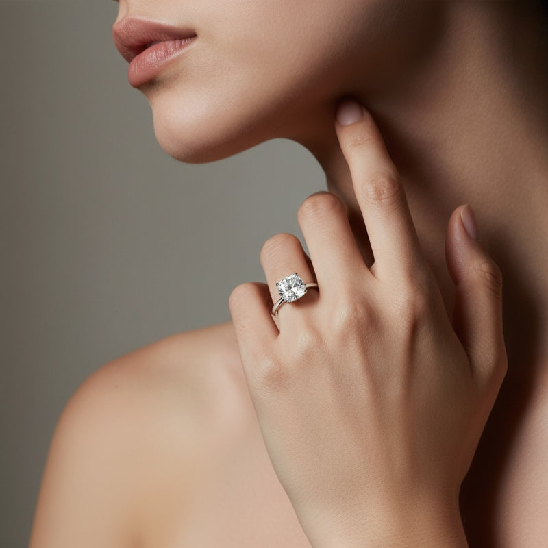 Model wearing cushion east west solitaire ring
