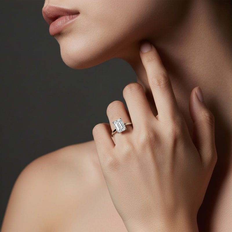 Model wearing emerald east west solitaire ring