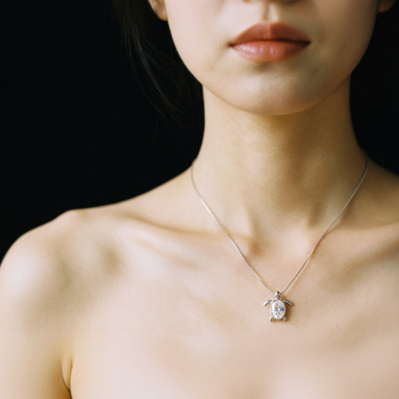 Model wearing oval bezel set turtle pendant