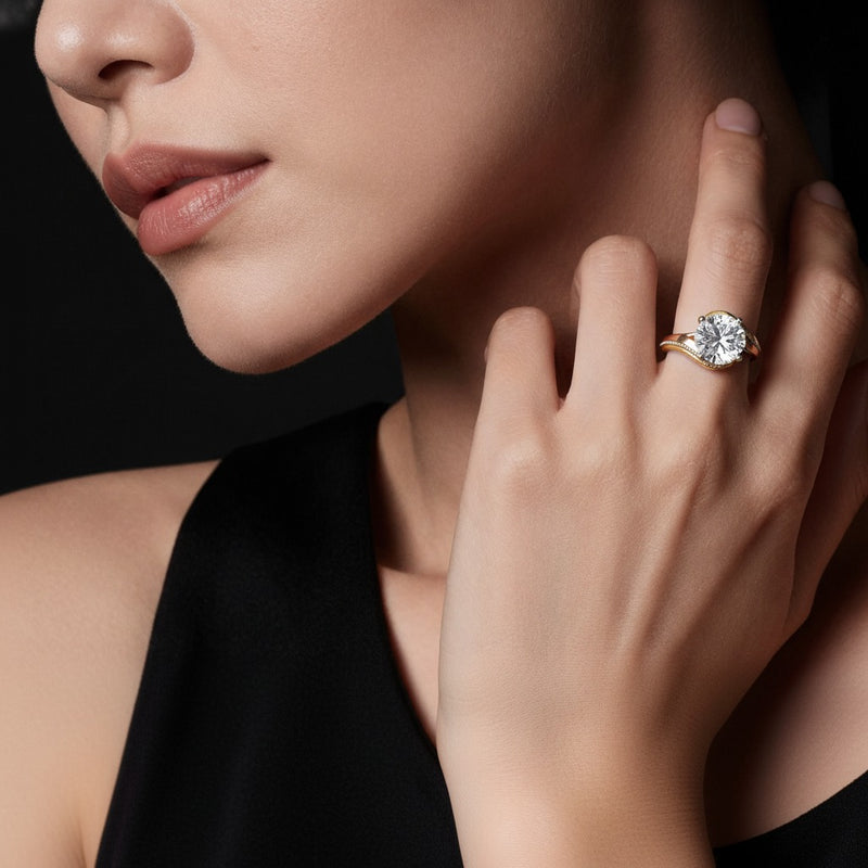 Model wearing round solitaire engagement ring