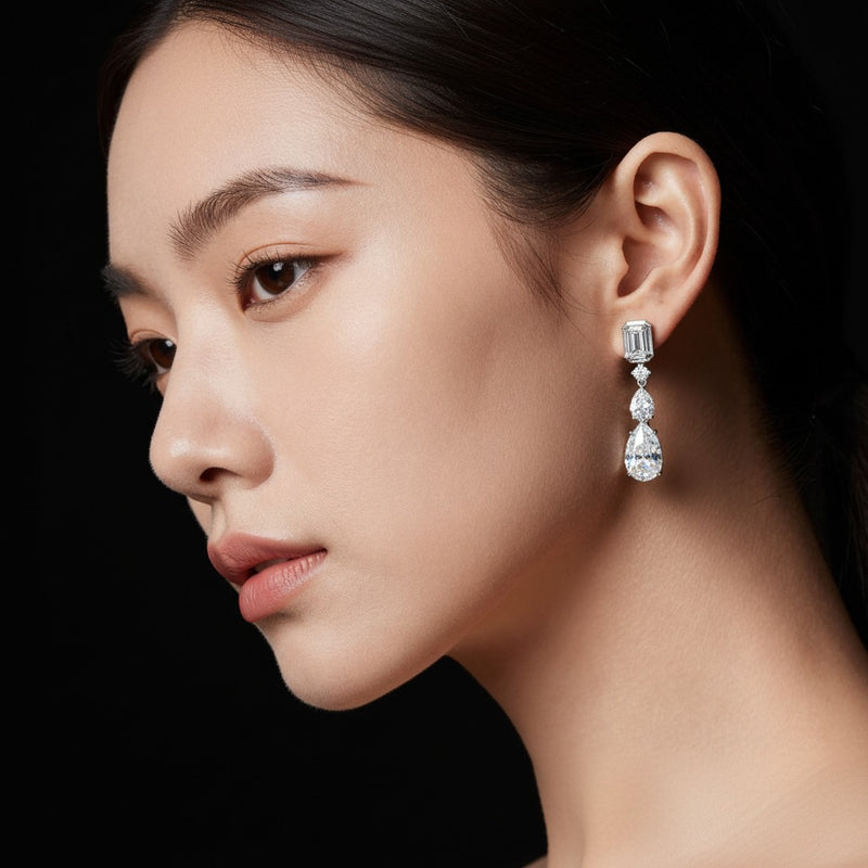 Model wearing pear dangle earrings