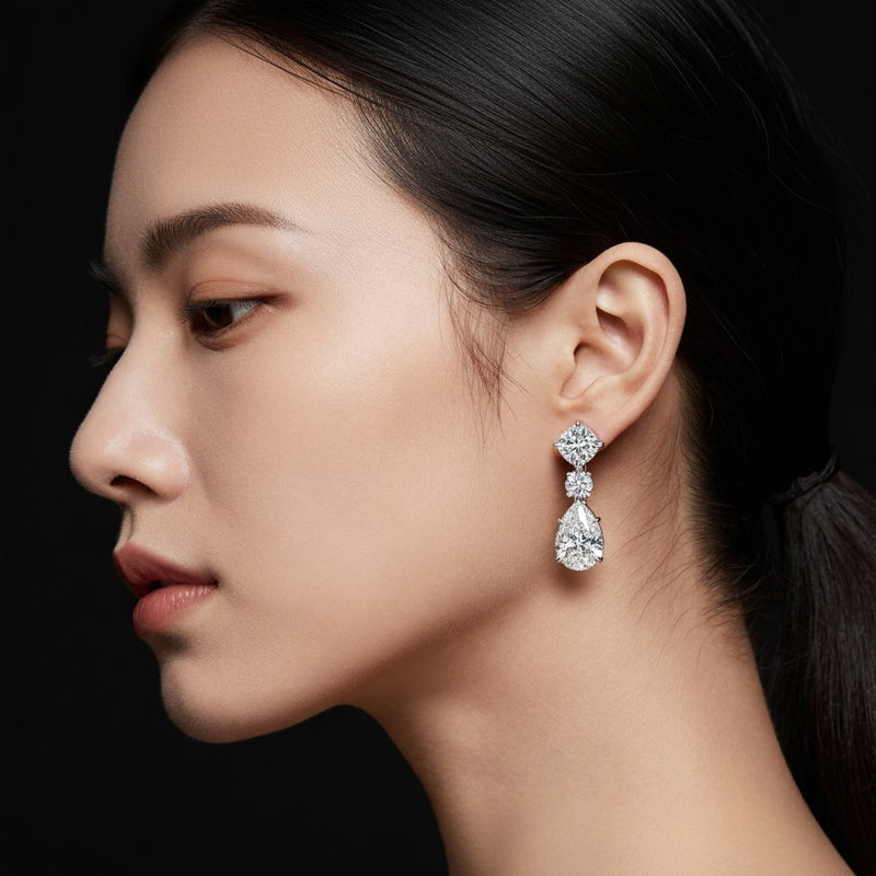 Model wearing pear dangle earrings