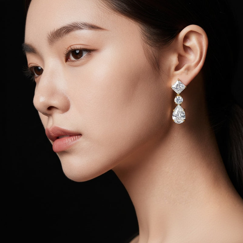 Model wearing pear dangle earrings