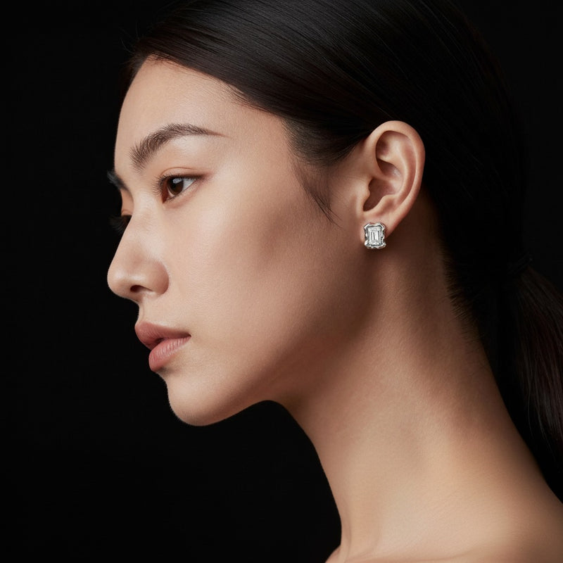Model wearing emerald organic design stud earrings