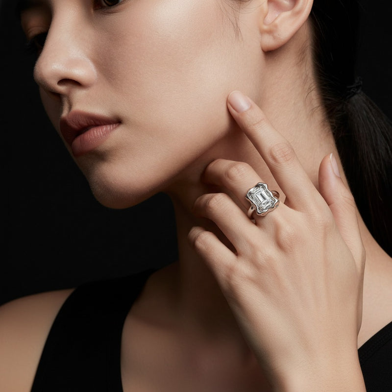Model wearing emerald organic design solitaire ring
