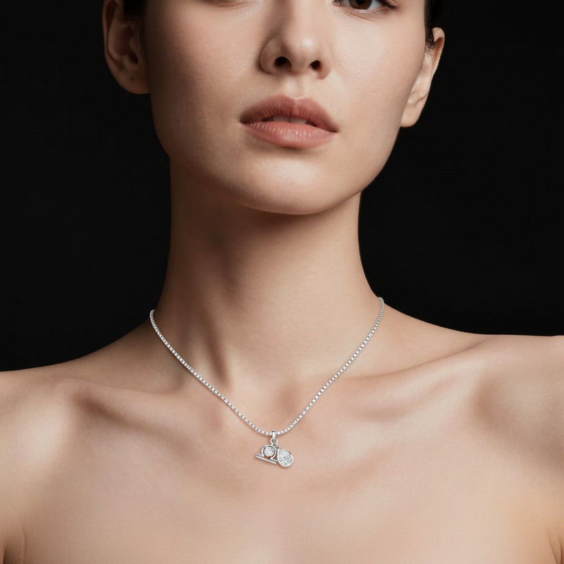 Model wearing pear zodiac pendant