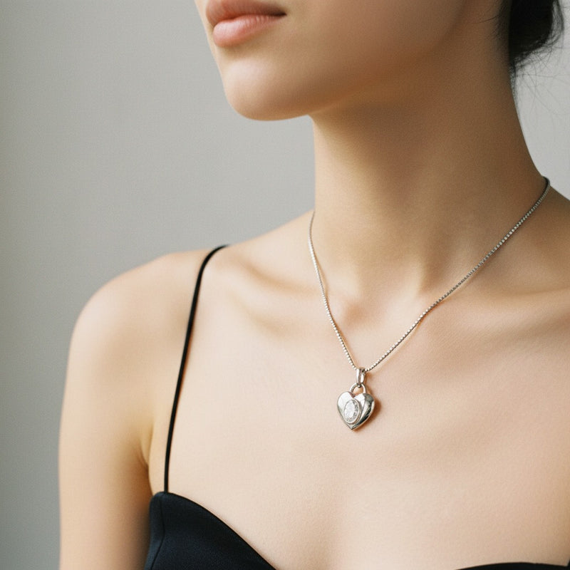 Model wearing oval heart pendant