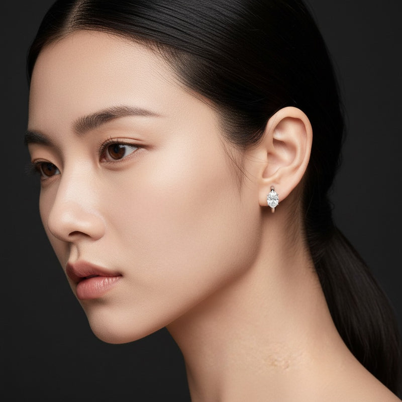 Model wearing oval huggie cuff earrings
