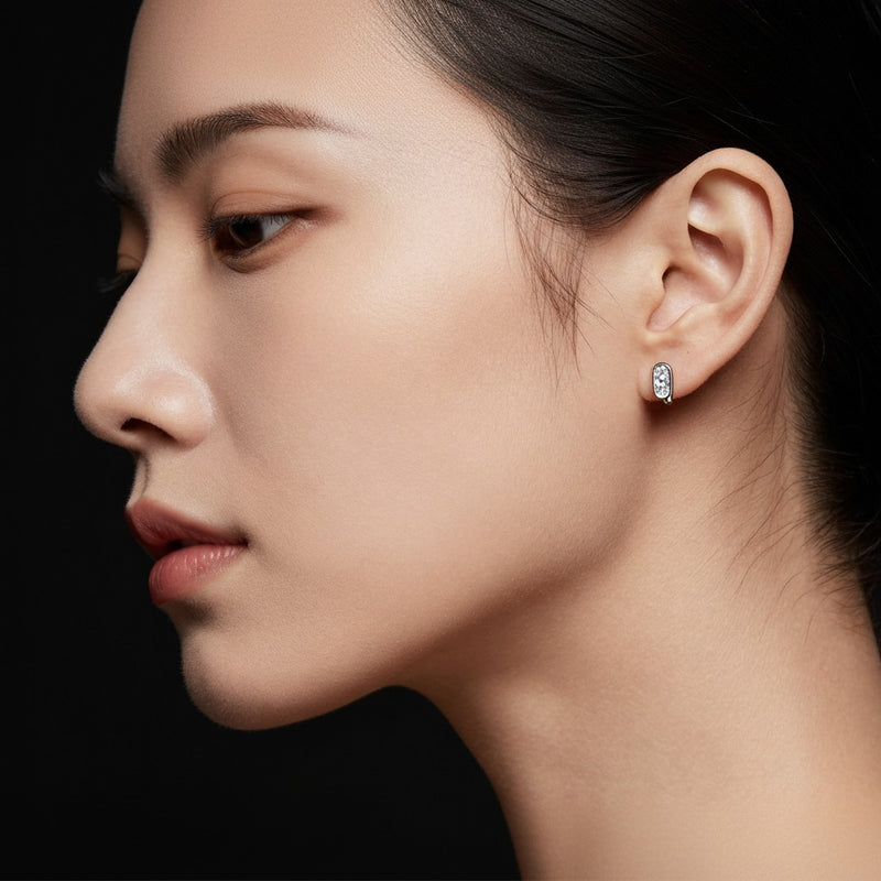 Model wearing oval huggie cuff earrings