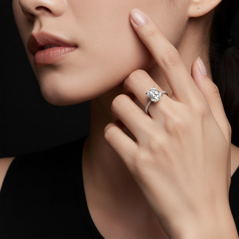 Model wearing cushion bold accented east west set engagement ring