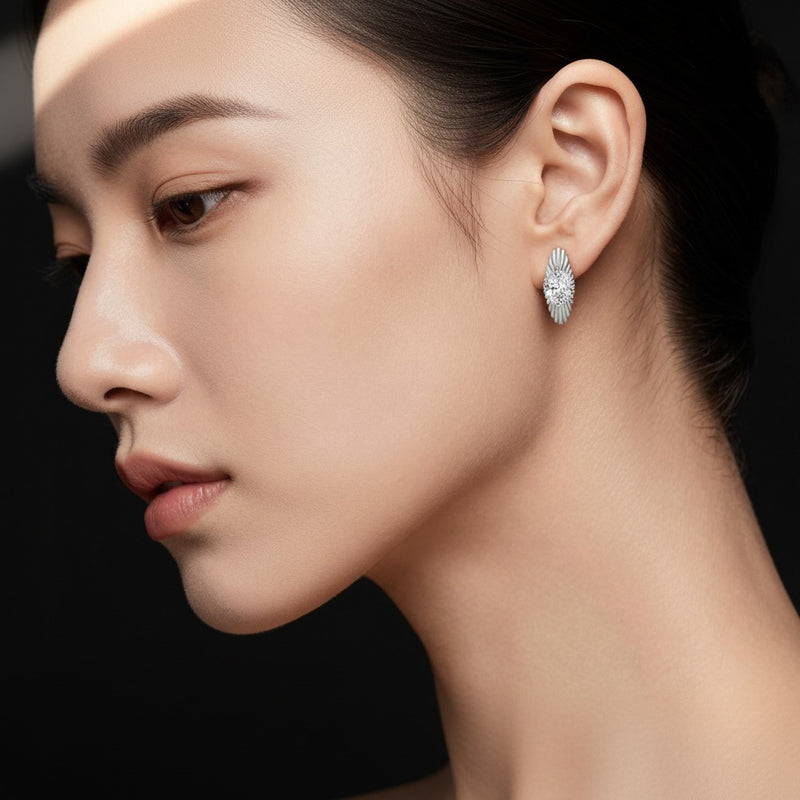 Model wearing oval huggie earrings