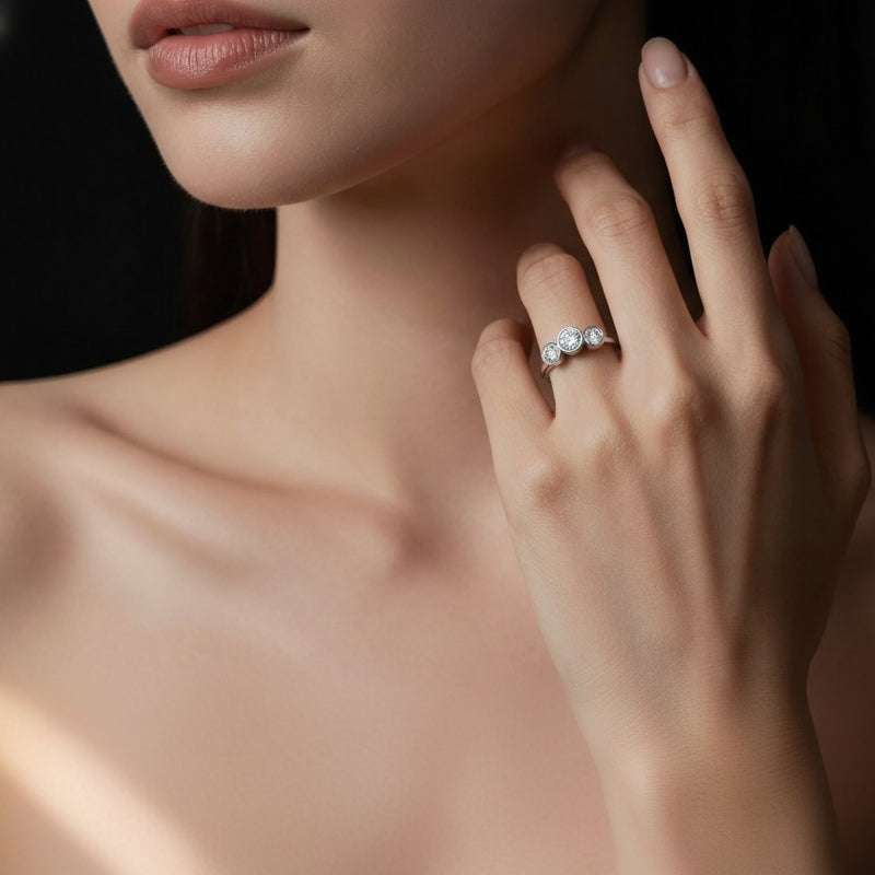 Model wearing round three stone ring