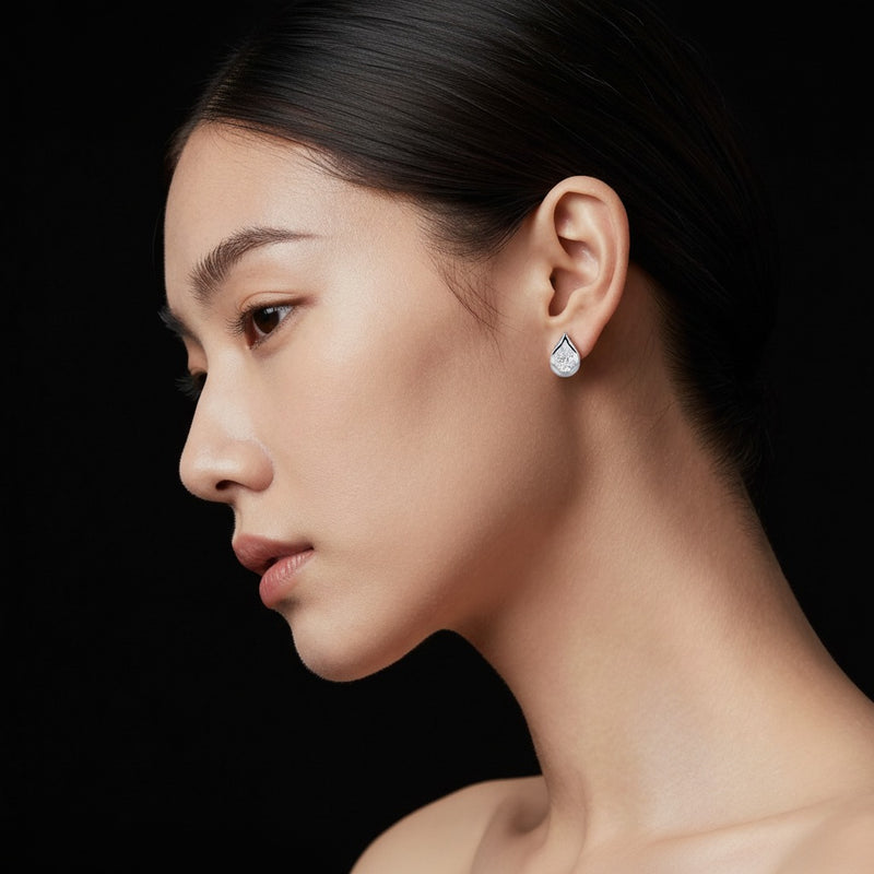 Model wearing pear stud earrings