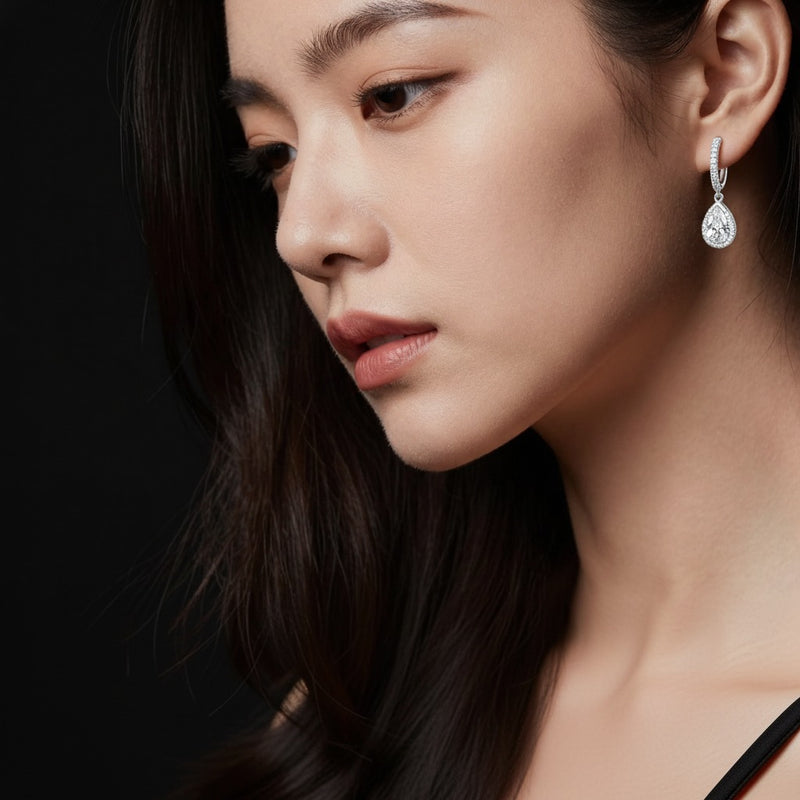Model wearing pear dangle earrings