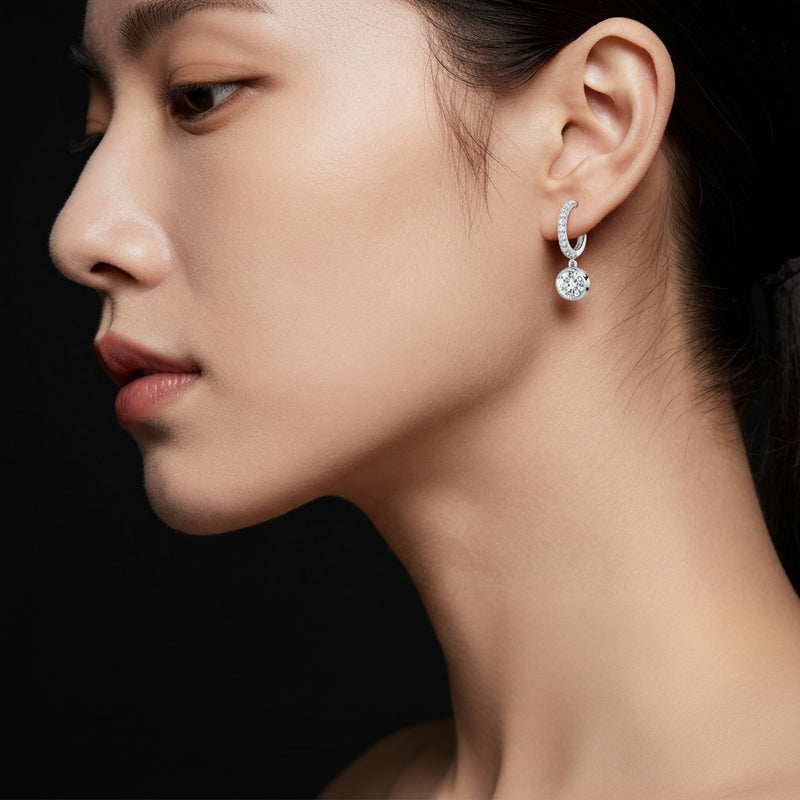 Model wearing round dangle earrings
