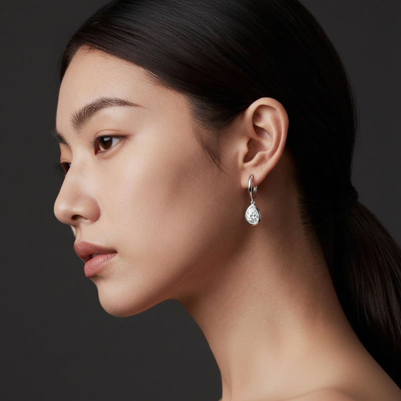 Model wearing pear dangle earrings