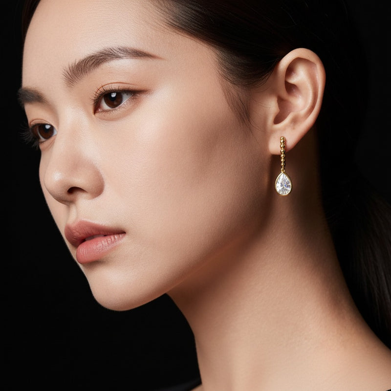 Model wearing pear dangle earrings