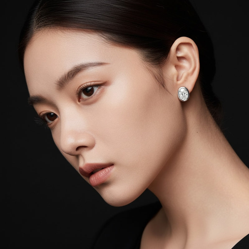 Model wearing oval stud earrings