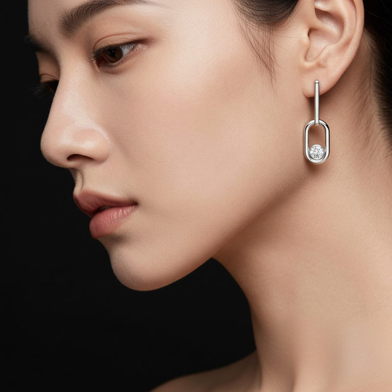 Model wearing round bezel set paperclip dangle earrings