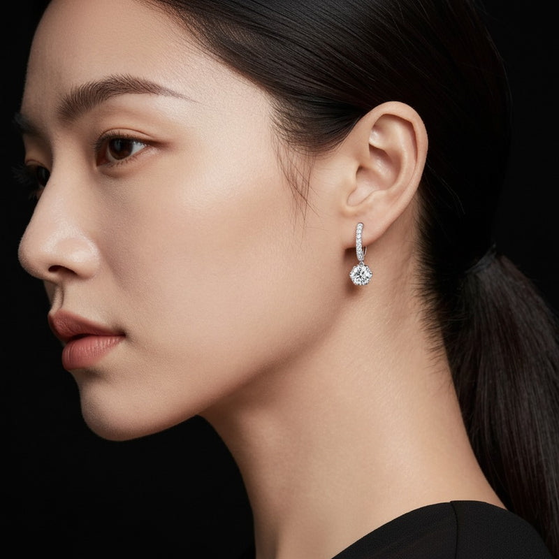 Model wearing round dangle hoop earrings