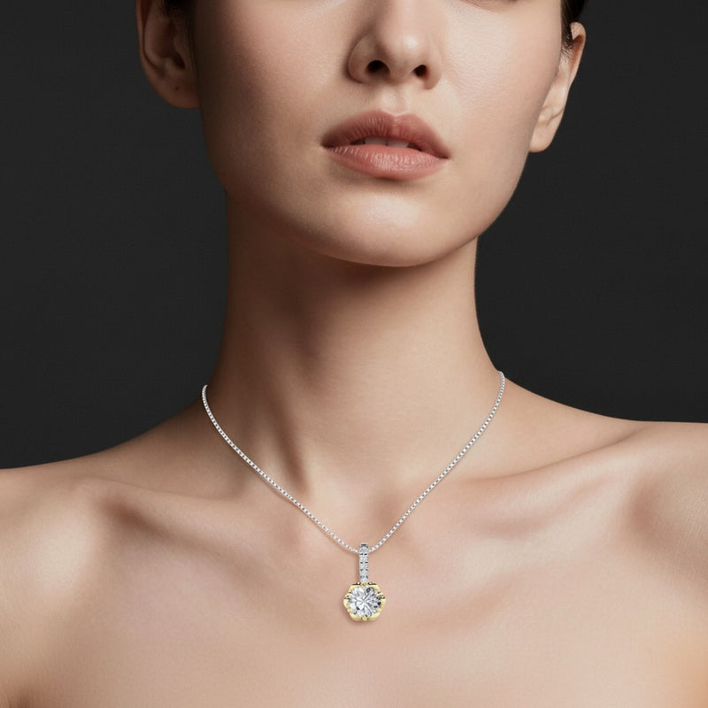 Model wearing round two tone pendant
