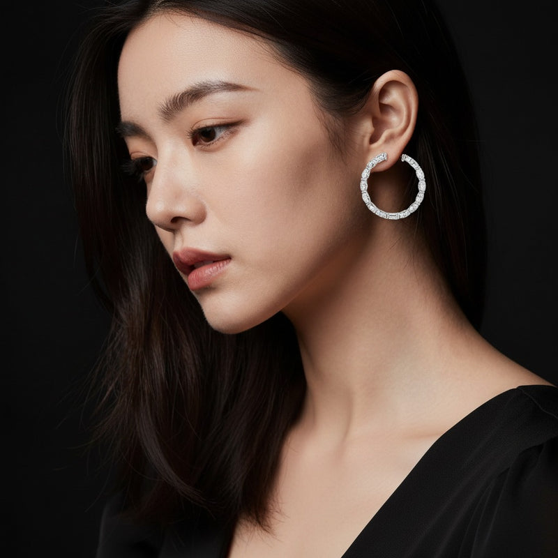 Model wearing oval inside out hoop earrings
