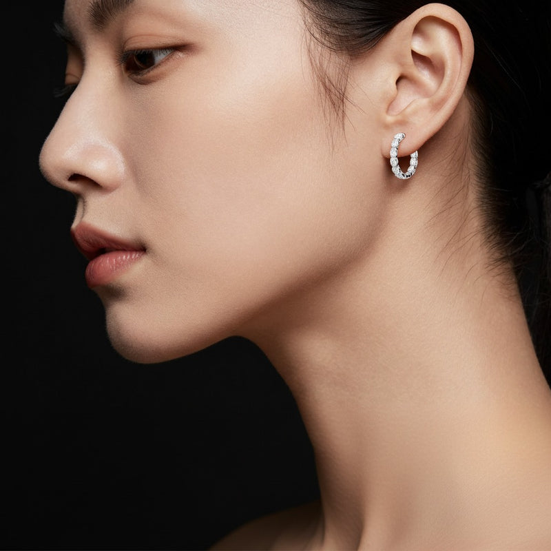 Model wearing oval lab grown diamond inside out hoop earrings