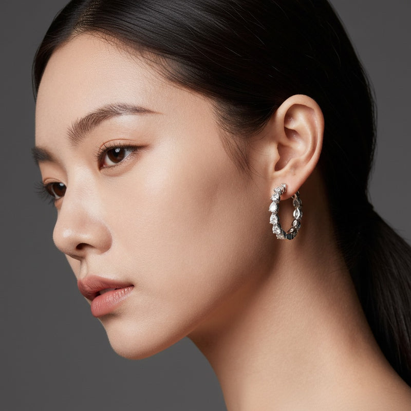 Model wearing pear inside out hoop earrings