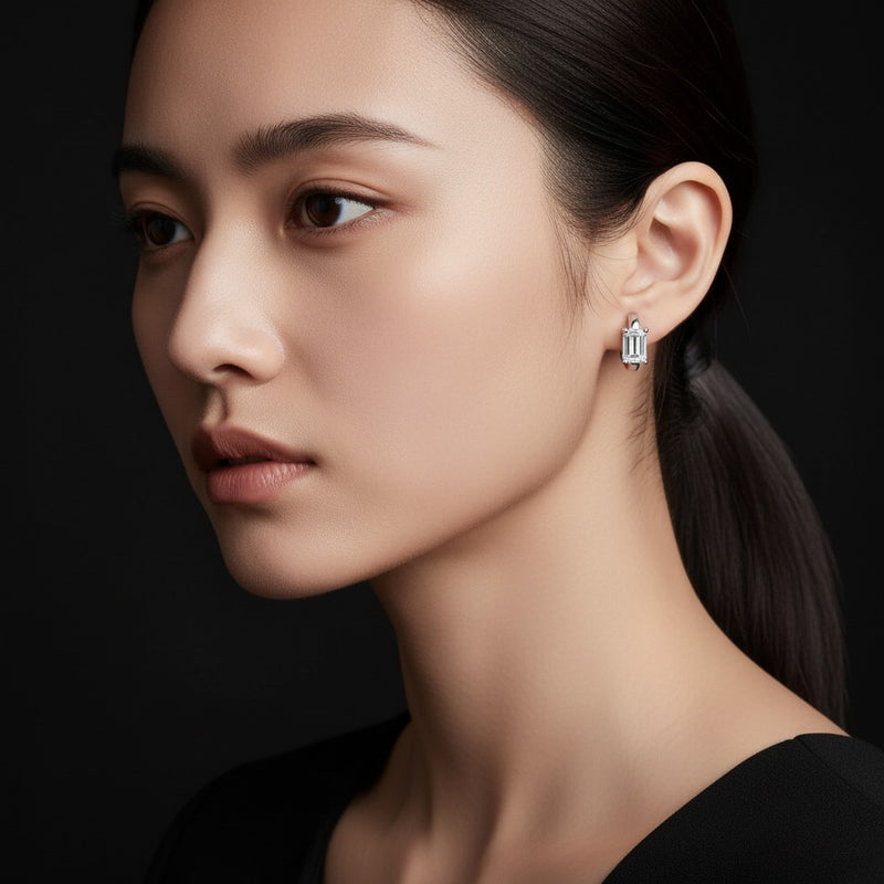Model wearing emerald huggie earrings