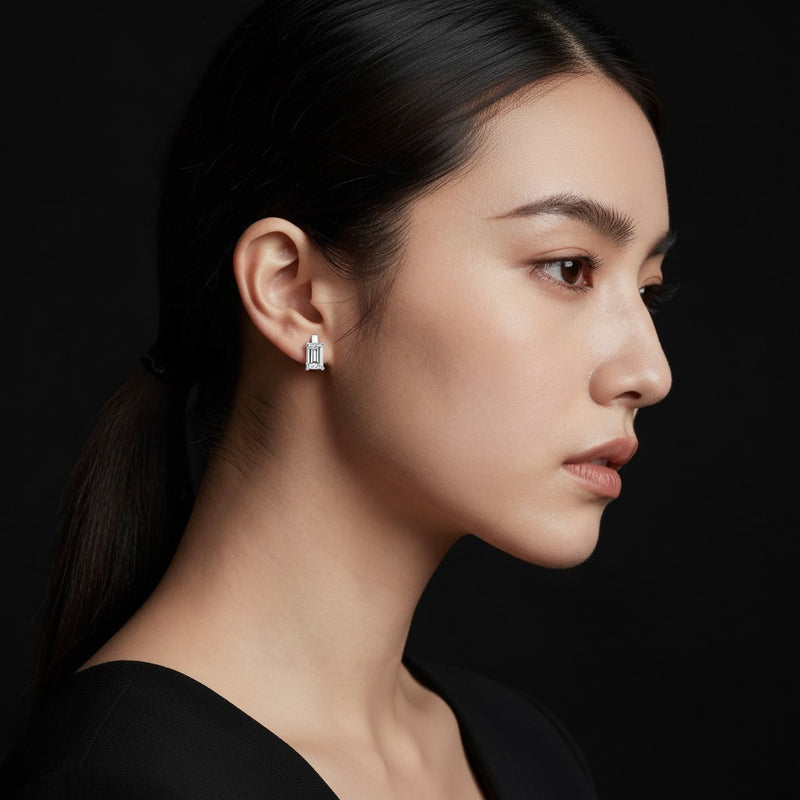 Model wearing emerald huggie earrings