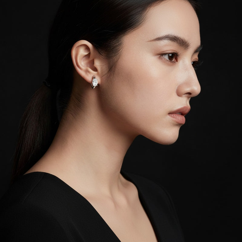 Model wearing oval huggie earrings