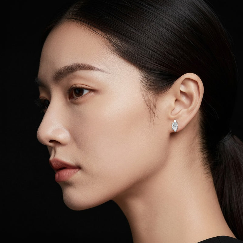 Model wearing oval huggie earrings