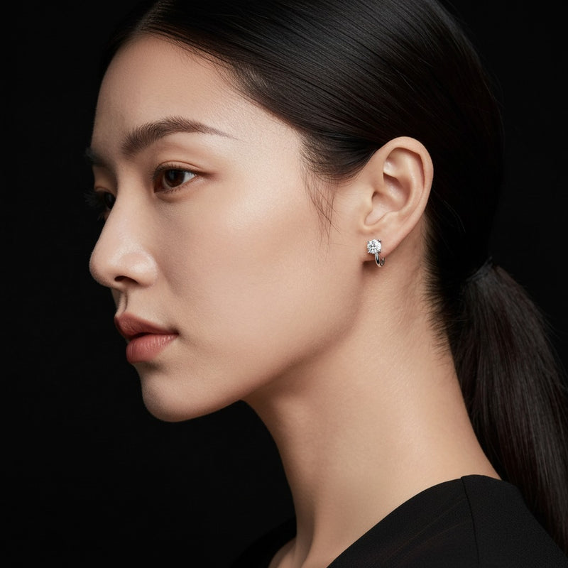 Model wearing round huggie earrings