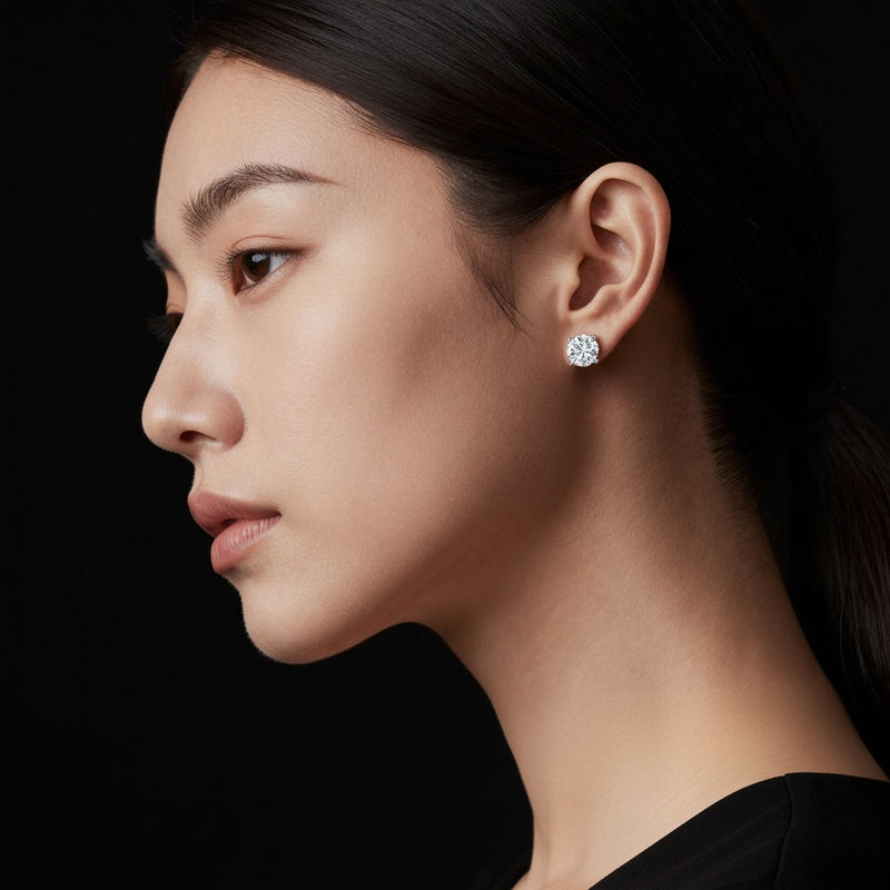 Model wearing round stud earrings